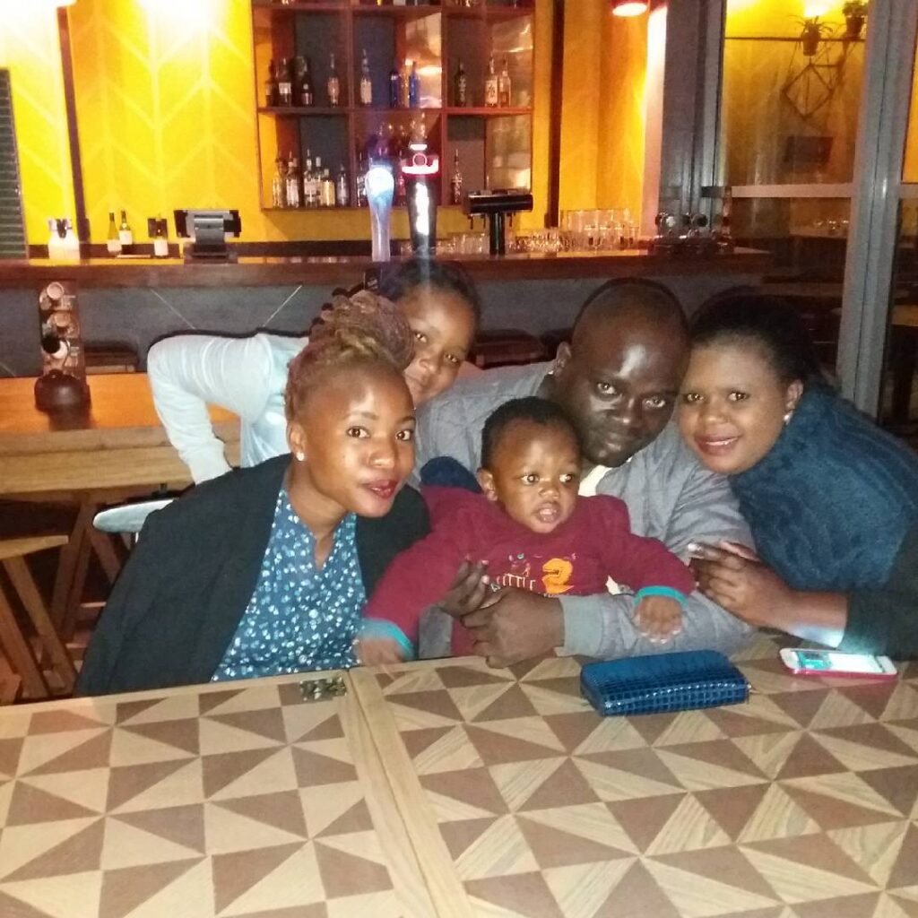 Humbulani with his family, wife, and children 
