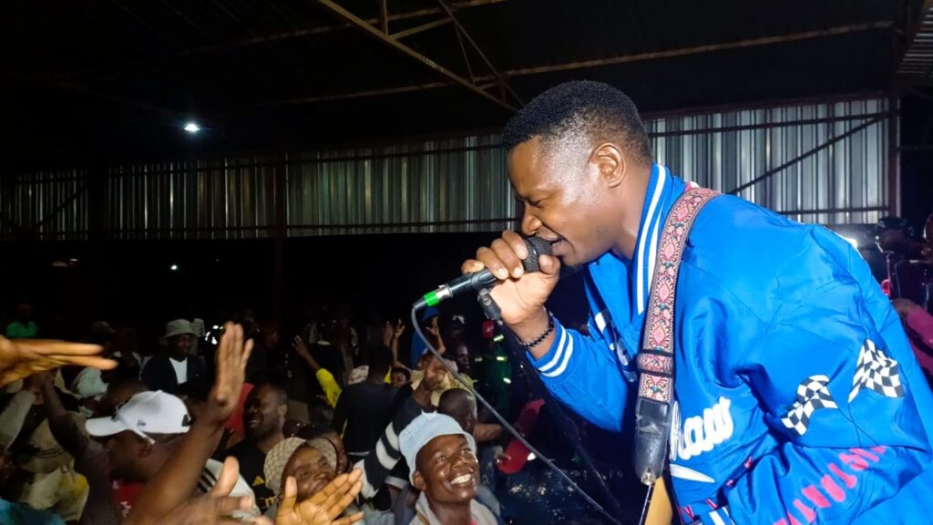 Simon Mutambi performing on stage.